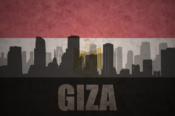 abstract silhouette of the city with text Giza at the vintage egyptian flag
