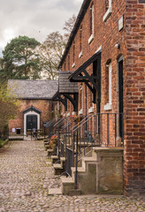 Fototapeta premium Styal, Wilmslow Cheshire, UK. Novermber 7th 2016. Autumn colours over mill cottages at Styal Village, Wilmslow, Cheshire, UK