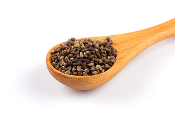 Decorticated cardamom seeds in a wooden spoon
