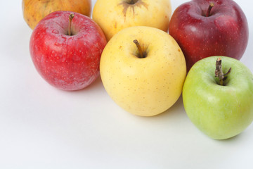 Colorful apples on white background. Fresh ripe apple fruits in different colors: red, green, orange.