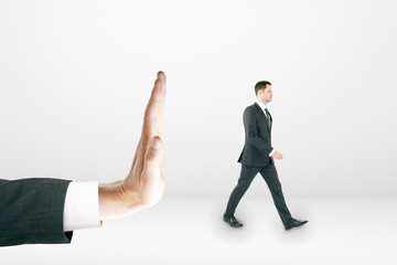 Businessman walking away from huge palm