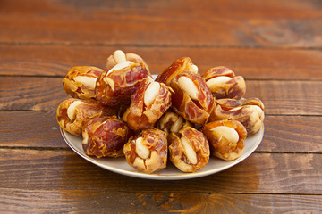 Delicious ripe figs on  plate lying on  wooden background