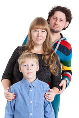 Two adult parents stand with an eight-year son. Isolated white background