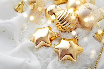 Obraz na płótnie Canvas gold christmas ornaments and snow