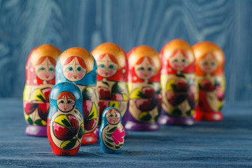 beautiful Russian matreshka doll on blue wooden background