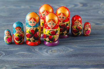beautiful Russian matreshka doll on blue wooden background