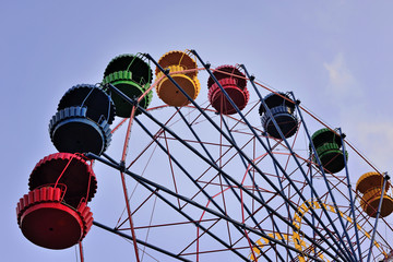 Ferris wheel on the background of blue sky