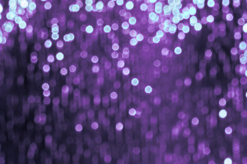 Glitter sparkling abstract purple bokeh defocused background