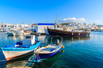 Fototapeta premium Traditional Greek fishing boats in Naoussa port at sunset time, Paros island, Greece
