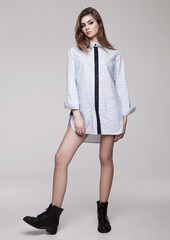 Beautiful young girl wearing shirt fashion on grey