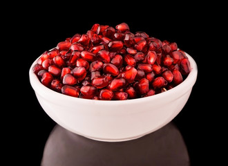 Garnet on a plate reflected on black background