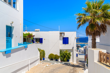 Typical Greek whitewashed houses on street in Naoussa town on Paros island, Greece