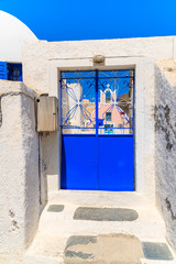 Blue door of entrance to typical church in Oia village, Santorini island, Greece