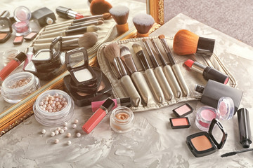 Decorative cosmetic set on grey textured background