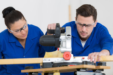 student in carpentry class using circular saw