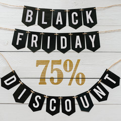 Black Friday seventy five percent Discount paper banner garland lettering hanging on white barn wood planks background. Luxurious square holiday flyer.