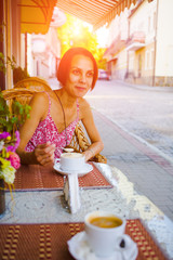 The girl drinks coffee.