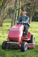 Fototapeta premium Portrait of man driving mower
