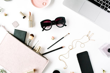 Flat lay, top view office table desk frame. feminine desk workspace with laptop, clutch, cosmetics, phone, sunglasses, lipstick rose buds on white background.