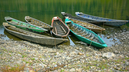Fototapeta premium Old wooden boats moored to the bank of the river