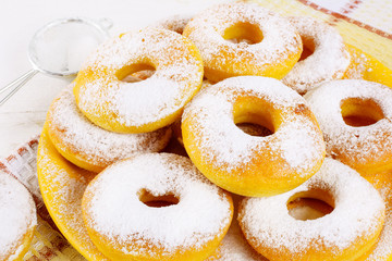 Stack of fried donuts on yellow plate