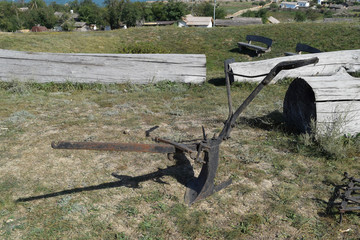 The exhibit of the old plow on the grass. an ancient technique for digging soil