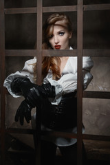 Beautiful woman in pirate style as prisoner