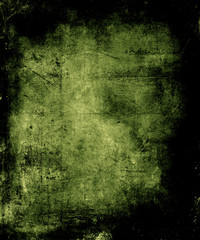 Scary abstract vintage grunge background with faded central area for your text or picture, scratched halloween green background