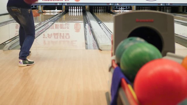 Girl throws ball in bowling. 4k