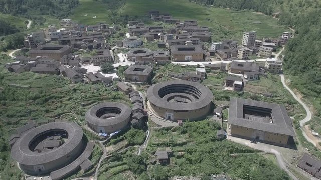Aerial drone flight over tulou round houses in Fujian province China