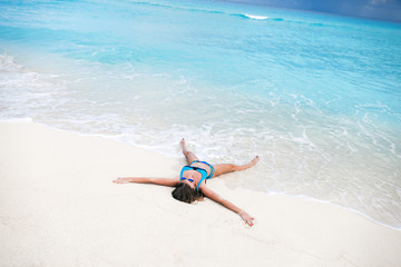 Fototapeta na wymiar Woman on sandy beach enjoying tropical holidays