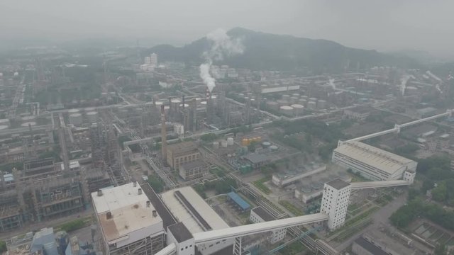 Aerial overview of an oil refinery, heavy industry and polluting smokestacks in Guangzhou, China
