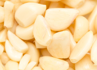 peeled garlic as background