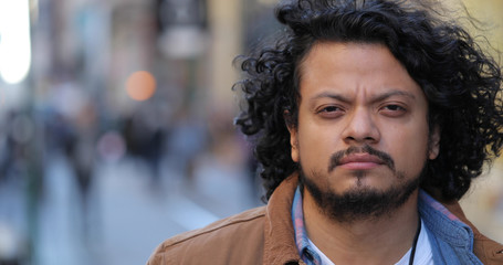 Latino hispanic man in city face portrait