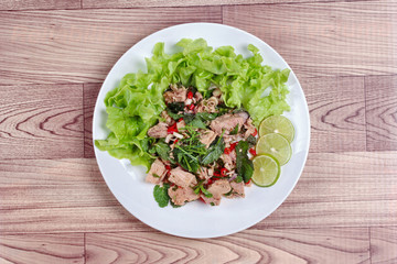 Spicy and sour mixed vegetable salad with canned tuna served .