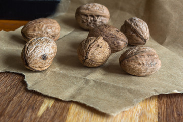 Composition with walnuts over brown wooden background