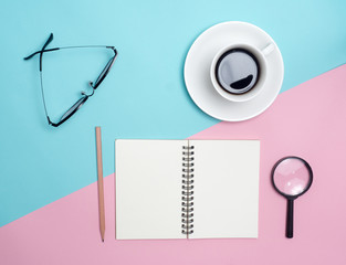 Top view of colorful cup of coffee and glasses on color blue and pink  background for create idea for business or design .Relax coffee time .
 (flat lay)