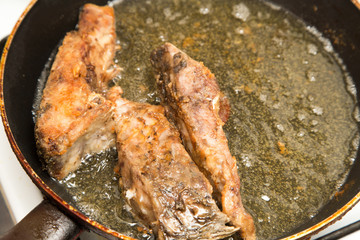 fish is fried in a pan