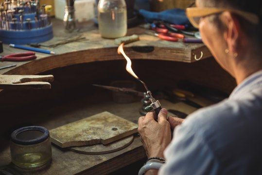Craftswoman using blow torch