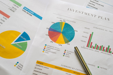 Investment planning and reporting concept. Closed up of invesment planning report containing colourful graph of asset allocation planning.