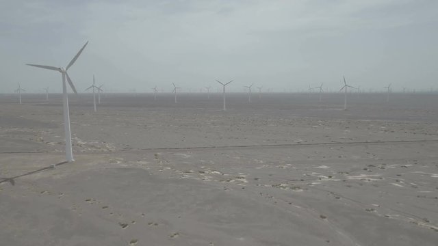 Rising over large windfarm in central Chinese desert
