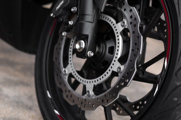 Fototapeta na wymiar Close up and selective focus motorbike wheel and break detail