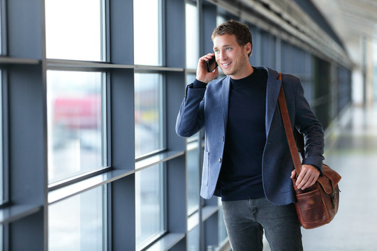 Smartphone business man talking on mobile phone in airport - travel lifestyle. Businessman using smartphone calling on phone walking in corporate building or on work commute in public transit area.