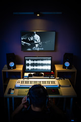 Fototapeta premium sound engineer, technician, editor, producer working in digital editing studio for TV broadcasting, recording, post production, film, music video production