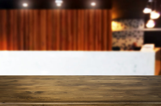 image of wooden table in front of abstract blurred background of