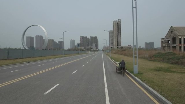 Tracking View Cyclist In Ghost City China