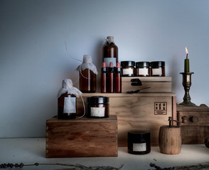 Obraz na płótnie Canvas old pharmacy. bottles, jars, candle on wooden shelves