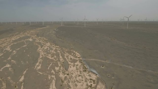 Panoramic view of dry riverbed and large wind energy farm in China
