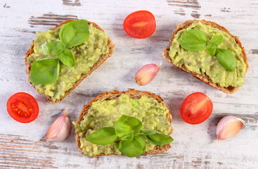 Freshly sandwiches with paste of avocado and ingredients, healthy food and nutrition