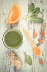 Vintage photo, Ingredients and fresh cocktail from spinach on wooden background, healthy nutrition